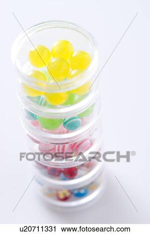 Stock Image - Different colored beads in container stack. Fotosearch
