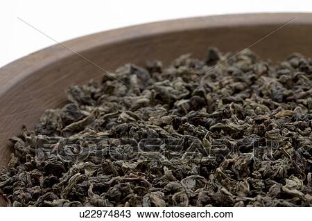 Stock Image - Dried Tea Leaves of Oolong Tea in Bowl. Fotosearch