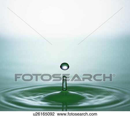 Drop of liquid falling into water View Large Photo Image Stock Image - Drop of liquid falling into water. Fotosearch