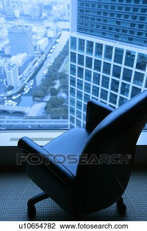 Empty office chair faced towards window with a view over the city View Large Photo Image Stock Image - Empty office chair faced towards window with a view over the city. Fotosearch