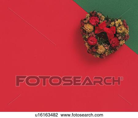 Stock Image - Floral Christmas wreath in the shape of a heart. Fotosearch