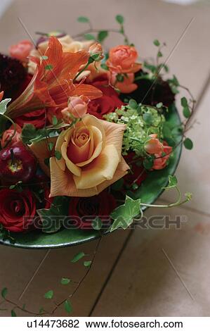 Stock Image - Flower arrangement in a bowl on a table. Fotosearch