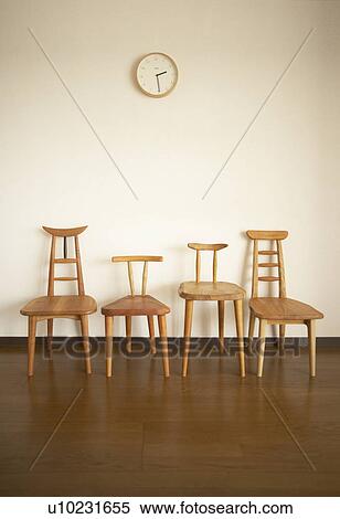 Four wooden chairs against white wall View Large Photo Image Stock Photography - Four wooden chairs against white wall. Fotosearch