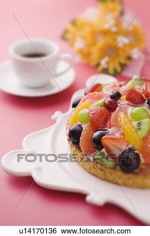 Stock Photograph - Fruit tart and a cup of coffee, red background. Fotosearch