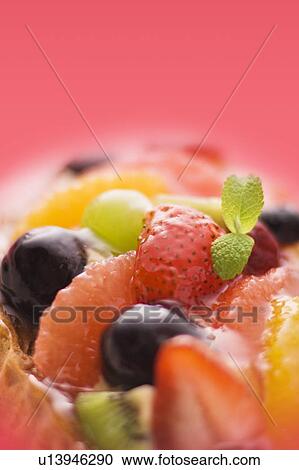 Stock Image - Fruit tart, close up, colored background. Fotosearch
