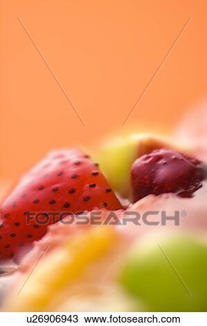 Stock Image - Fruit tart, close up, colored background. Fotosearch