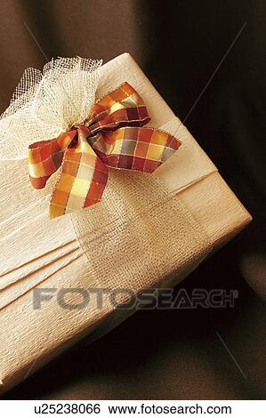 Gift wrapped in white wrapping paper with a checked bow View Large Photo Image Stock Photograph - Gift wrapped in white wrapping paper with a checked bow. Fotosearch