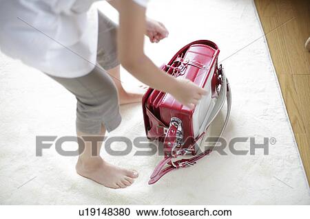 Stock Image - Girl and backpack for school on rug. Fotosearch