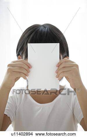 Girl holding blank card, hiding face View Large Photo Image Picture - Girl holding blank card, hiding face. Fotosearch