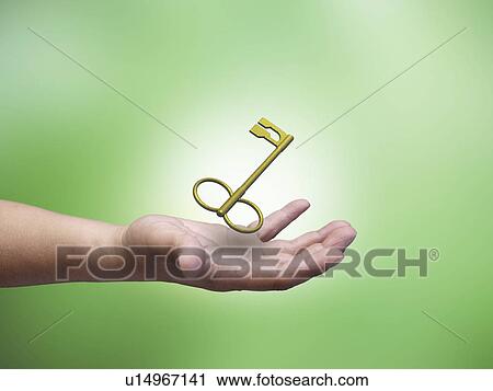 Stock Image - Hand catching a key. Fotosearch