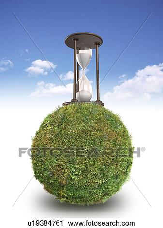 Stock Image - Hourglass on grass covered sphere. Fotosearch