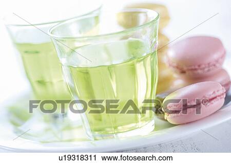 Stock Image - Iced green tea and pink macaroons. Fotosearch