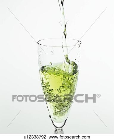 Stock Image - Iced green tea being poured into a glass. Fotosearch
