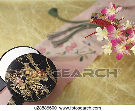 Stock Image - Japanese hand mirror, hairpin and Obi sash. Fotosearch