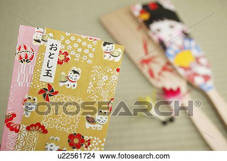 Picture - Japanese money envelopes with Battledore in the background. Fotosearch