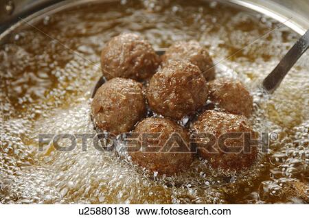 Stock Photo - Meatballs fried in pan, close up. Fotosearch