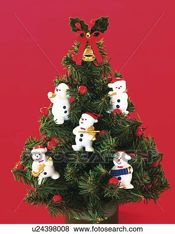 Stock Photo - Miniature Christmas tree decorated with snowmen figurines. Fotosearch