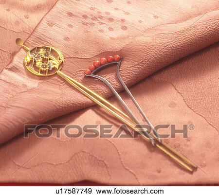 Stock Photo - Ornamental hairpins on pink fabric. Fotosearch