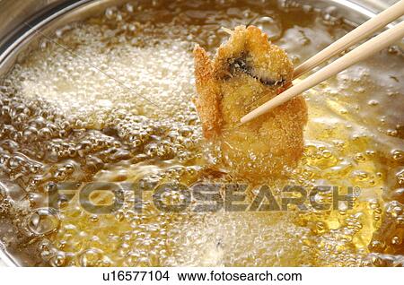 Picture - Oyster fried in pan, close up. Fotosearch