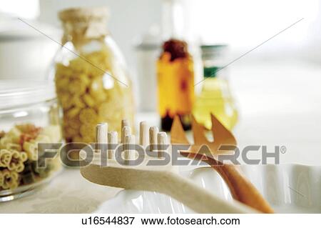 Stock Photo - Pasta servers and pasta in jars. Fotosearch