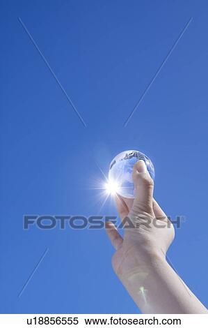 Person holding glass globe up high View Large Photo Image Stock Photography - Person holding glass globe up high. Fotosearch