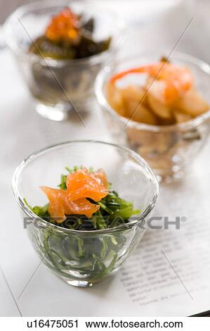 Stock Image - Pickled greens in glass dishes. Fotosearch