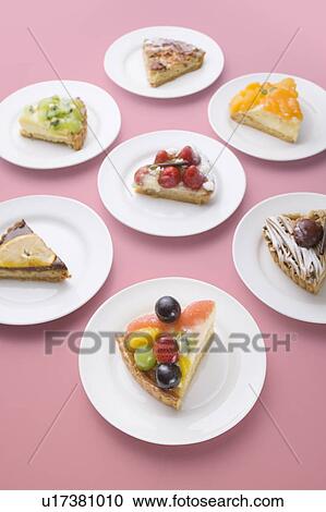 Pieces of tart on plates, pink background View Large Photo Image Stock Image - Pieces of tart on plates, pink background. Fotosearch