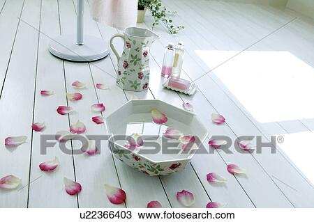 Stock Image - Pink flower petals and aromatherapy oils. Fotosearch