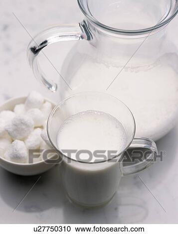 Pitcher and cup full of warm milk View Large Photo Image Stock Image - Pitcher and cup full of warm milk. Fotosearch