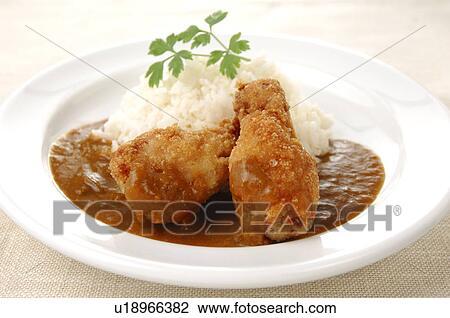 Stock Image - Plate of curry and rice with fried chicken. Fotosearch