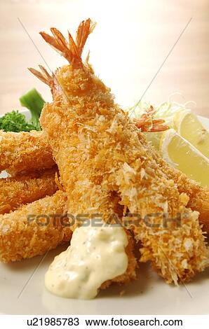 Stock Image - Plate of deep fried shrimps, close up. Fotosearch