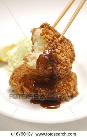 Stock Photo - Plate of fried croquettes, close up, white background. Fotosearch