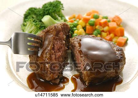 Stock Photography - Plate of hamburger steak, close up. Fotosearch