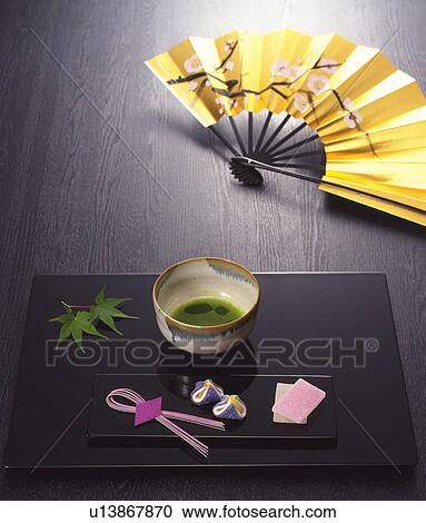 Stock Image - Powdered green tea and Japanese sweets. Fotosearch