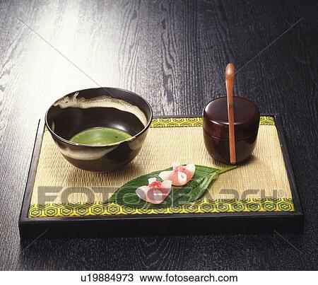 Stock Image - Powdered green tea and Japanese sweets. Fotosearch