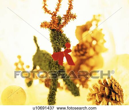 Reindeer Christmas ornament surrounded by baubles and pine cones View Large Photo Image Stock Photo - Reindeer Christmas ornament surrounded by baubles and pine cones. Fotosearch