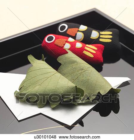 Rice cakes wrapped in leaves and carp dolls for Children's day View Large Photo Image Stock Photo - Rice cakes wrapped in leaves and carp dolls for Children's day. Fotosearch
