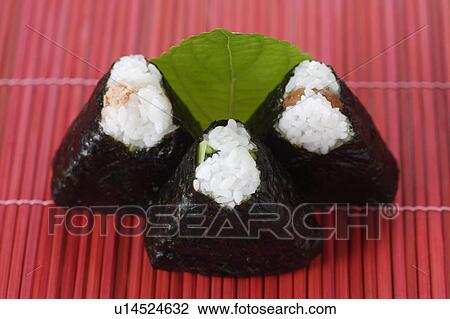 Stock Image - Rice dumplings wrapped in seaweed. Fotosearch
