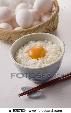 Row egg on bowl of rice, white background View Large Photo Image Picture - Row egg on bowl of rice, white background. Fotosearch