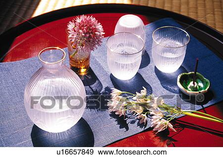 Stock Photo - Sake and flower arrangement. Fotosearch
