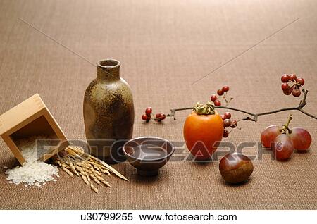 Sake, rice and fruits on brown background View Large Photo Image Stock Photography - Sake, rice and fruits on brown background. Fotosearch