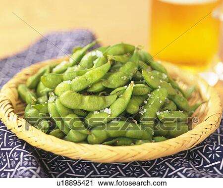 Stock Image - Salted soybeans in a basket. Fotosearch