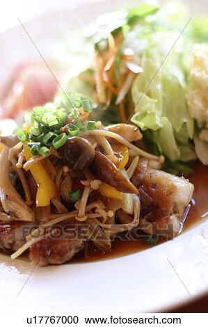 Stock Image - Sauteed pork with ginger and fresh salad. Fotosearch