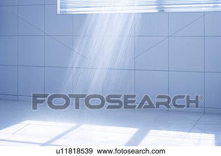 Stock Photo - Shower stream in a tiled bathroom. Fotosearch