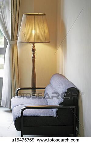 Stock Photo - Sofa and lamp in living room. Fotosearch