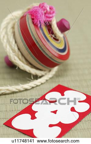 Spinning top and an envelope used for giving money in the new year View Large Photo Image Stock Image - Spinning top and an envelope used for giving money in the new year. Fotosearch