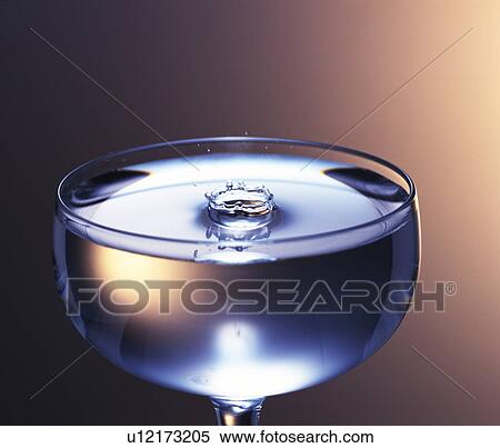 Stock Photography - Splash in a cocktail glass. Fotosearch