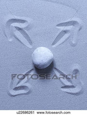 Stock Image - Stone on sand with arrows. Fotosearch