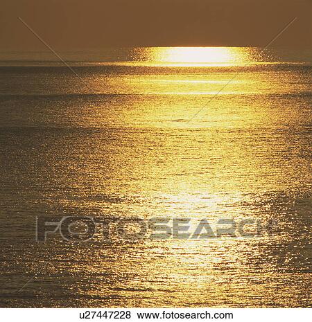 Stock Photo - Sun setting over the ocean, Kashiwazaki, Niigata Prefecture, Japan. Fotosearch