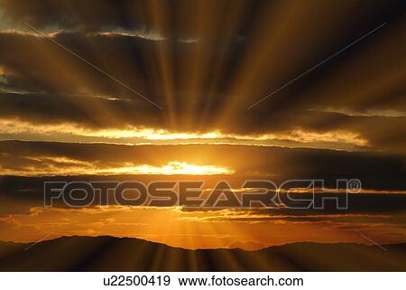 Sunbeams shining over a mountain range at sunset, Chaoyang, Otsu, Shiga Prefecture, Japan View Large Photo Image Stock Photo - Sunbeams shining over a mountain range at sunset, Chaoyang, Otsu, Shiga Prefecture, Japan. Fotosearch